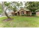 Charming brick home with lush lawn, mature trees, and well-maintained landscaping at 356 Remington Dr, Oviedo, FL 32765