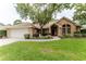 Inviting brick home features a well-manicured lawn, walkway, and attached two-car garage at 356 Remington Dr, Oviedo, FL 32765