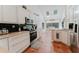 Spacious kitchen with white cabinets, granite countertops, tile floors, and stainless steel appliances at 356 Remington Dr, Oviedo, FL 32765