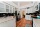 Well-lit kitchen with white cabinets, stainless steel appliances, and neutral countertops at 356 Remington Dr, Oviedo, FL 32765