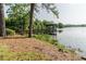 Scenic view of the lake featuring a wooden pier with a gazebo, ideal for relaxation and enjoying nature at 356 Remington Dr, Oviedo, FL 32765
