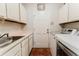 Bright laundry room features washer, dryer, white cabinets, and tiled floors at 356 Remington Dr, Oviedo, FL 32765