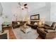 Spacious living room with a high ceiling, ceiling fan, and leather furniture and neutral tones at 356 Remington Dr, Oviedo, FL 32765