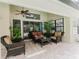 Cozy covered patio featuring comfortable seating, ceiling fan and views of the pool at 356 Remington Dr, Oviedo, FL 32765