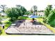 Community playground with swings, slide, and play equipment in a well-maintained park setting at 356 Remington Dr, Oviedo, FL 32765