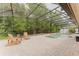 Backyard screened in pool area features mature trees and lounging chairs at 356 Remington Dr, Oviedo, FL 32765