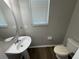 Powder room featuring a pedestal sink, toilet, and window with blinds at 3707 Andover Cay Blvd, Orlando, FL 32825