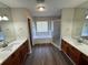 Bathroom featuring double vanities, a soaking tub, and a walk-in shower at 3707 Andover Cay Blvd, Orlando, FL 32825