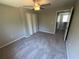 Carpeted bedroom features a ceiling fan and a closet with folding doors at 3707 Andover Cay Blvd, Orlando, FL 32825