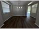 Dining room featuring modern lighting, and large windows with hardwood floors leading to an adjacent sitting room at 3707 Andover Cay Blvd, Orlando, FL 32825