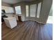 Updated kitchen with white cabinets, stainless steel appliances, an island, and a sliding glass door to the backyard at 3707 Andover Cay Blvd, Orlando, FL 32825