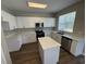 Well-equipped kitchen featuring white cabinets, stainless steel appliances, and an island for added counter space at 3707 Andover Cay Blvd, Orlando, FL 32825