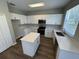 Bright kitchen with quartz countertops, white cabinets, stainless steel appliances, and an island at 3707 Andover Cay Blvd, Orlando, FL 32825