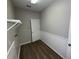 Laundry room with white wainscoting, a utility sink, and wood-look flooring at 3707 Andover Cay Blvd, Orlando, FL 32825