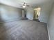 Spacious living room with plush carpeting and steps leading to another room at 3707 Andover Cay Blvd, Orlando, FL 32825