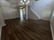 Open-concept living room with hardwood floors, modern lighting, and neutral colors providing an airy feel at 3707 Andover Cay Blvd, Orlando, FL 32825