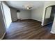 Spacious living room featuring dark wood-look flooring, a ceiling fan, and an arched doorway at 3707 Andover Cay Blvd, Orlando, FL 32825