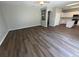 Bright open-concept living room with hardwood floors, neutral paint, and an archway leading into the kitchen at 3707 Andover Cay Blvd, Orlando, FL 32825