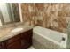 Bathroom featuring a soaking tub, granite counters, and tile backsplash at 4035 Palo Alto Ct, Orlando, FL 32817