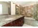 Double vanity bathroom with granite counters, tub, and tile floors at 4035 Palo Alto Ct, Orlando, FL 32817