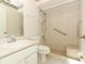 Well-lit bathroom featuring a walk-in shower with grab bars at 4035 Palo Alto Ct, Orlando, FL 32817