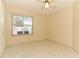 Bright bedroom featuring tile floors, a window, and a ceiling fan at 4035 Palo Alto Ct, Orlando, FL 32817