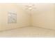 Simple bedroom featuring tile floors, fan, and large windows at 4035 Palo Alto Ct, Orlando, FL 32817