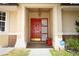 Welcoming front door with sidelights, an overhead light, and a small bench creating an inviting entrance at 4035 Palo Alto Ct, Orlando, FL 32817