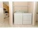 Convenient laundry area with washer, dryer, and shelving at 4035 Palo Alto Ct, Orlando, FL 32817