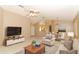Open-concept living room featuring tile floors, comfortable seating, and seamless flow into dining and kitchen areas at 4035 Palo Alto Ct, Orlando, FL 32817