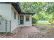 Fenced backyard featuring a brick patio and lush greenery surrounding the home at 409 E Gulley Ave, Oakland, FL 34760