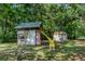 Large backyard featuring a custom playhouse with a slide and storage shed at 409 E Gulley Ave, Oakland, FL 34760