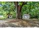 Expansive backyard featuring a storage shed and a charming playhouse with a slide, perfect for outdoor fun at 409 E Gulley Ave, Oakland, FL 34760