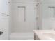 The shower-tub combo features a tiled surround and a built-in toiletry niche at 409 E Gulley Ave, Oakland, FL 34760