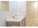 Bathroom vanity with a chrome faucet, light countertop, and storage below at 409 E Gulley Ave, Oakland, FL 34760