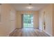 Bedroom features wood flooring, neutral paint, recessed lighting, and a sliding glass door at 409 E Gulley Ave, Oakland, FL 34760