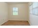 Cozy bedroom featuring neutral carpet and a window with bright natural light at 409 E Gulley Ave, Oakland, FL 34760