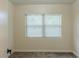 Bedroom with a large window, neutral walls, and carpet flooring at 409 E Gulley Ave, Oakland, FL 34760