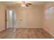Bedroom featuring wood-look flooring, neutral paint, a closet, and natural light at 409 E Gulley Ave, Oakland, FL 34760