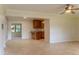 Spacious living room with tile flooring, neutral walls, and access to the kitchen and sunroom at 409 E Gulley Ave, Oakland, FL 34760