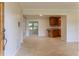 Open-concept living area with tile flooring and view to the kitchen featuring granite countertops at 409 E Gulley Ave, Oakland, FL 34760
