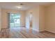 Spacious living room with a sliding glass door to the backyard and wood-look flooring at 409 E Gulley Ave, Oakland, FL 34760