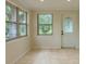 Sun Room with large windows, tile floor, and door with glass detailing at 409 E Gulley Ave, Oakland, FL 34760