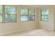 Sun Room features many windows with tile floor overlooking the backyard at 409 E Gulley Ave, Oakland, FL 34760