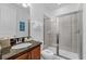 Bathroom showcasing a single sink vanity, granite countertops and stand-up shower at 441 Novi Path, Kissimmee, FL 34747