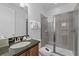 Bathroom featuring a single sink vanity, granite countertops and stand-up shower at 441 Novi Path, Kissimmee, FL 34747