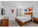 Bedroom with a wood frame bed, dresser, television, and comic themed art at 441 Novi Path, Kissimmee, FL 34747