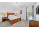 Comfortable bedroom featuring wood furniture, carpet, and a large window at 441 Novi Path, Kissimmee, FL 34747