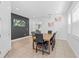 Inviting dining area with a large table set for six, modern tile flooring, and tasteful artwork at 441 Novi Path, Kissimmee, FL 34747