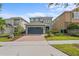 Charming home with a two-car garage and a lovely brick paved driveway, surrounded by mature landscaping at 441 Novi Path, Kissimmee, FL 34747